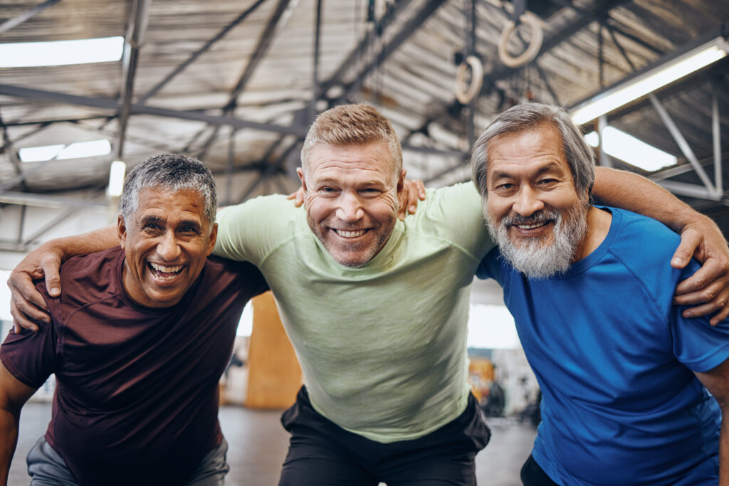 Three men leaning into camera happily