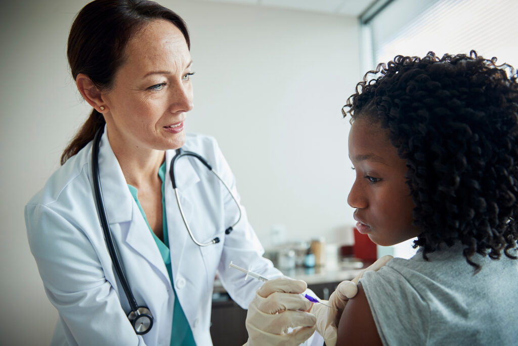 Female doctor checking young female patient
