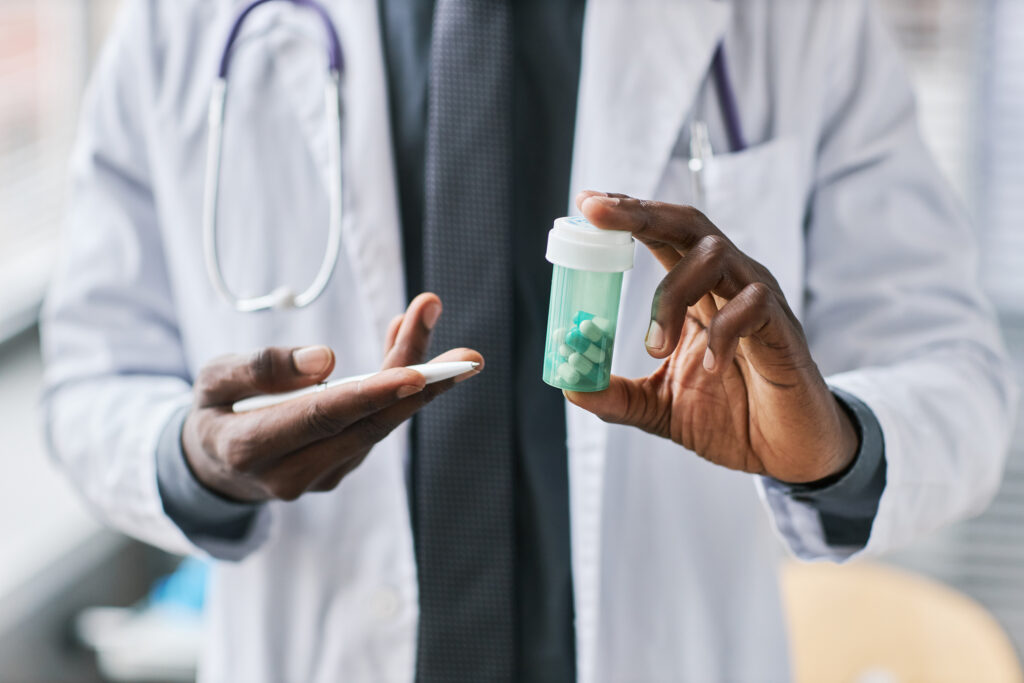 Medical professional holding bottle of medication