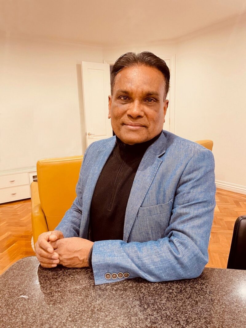 Middle aged doctor of south asian appearance in blue jacket