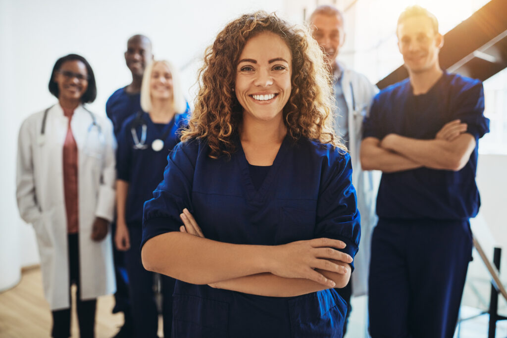 Female doctor standing in front of other medical professionals