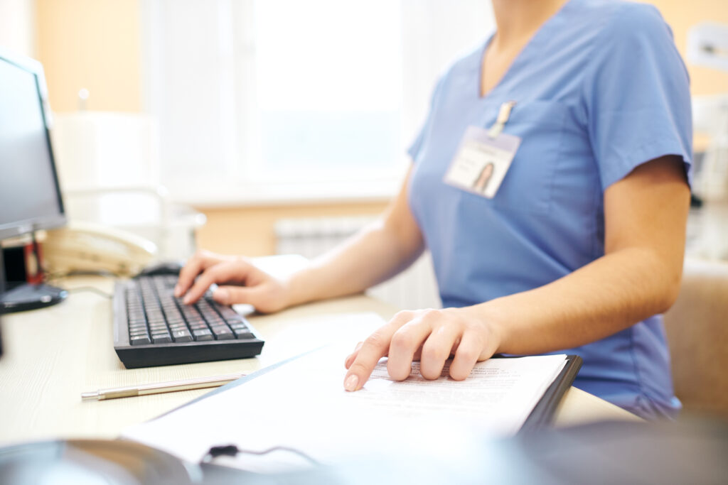 Health professional sitting at computer working
