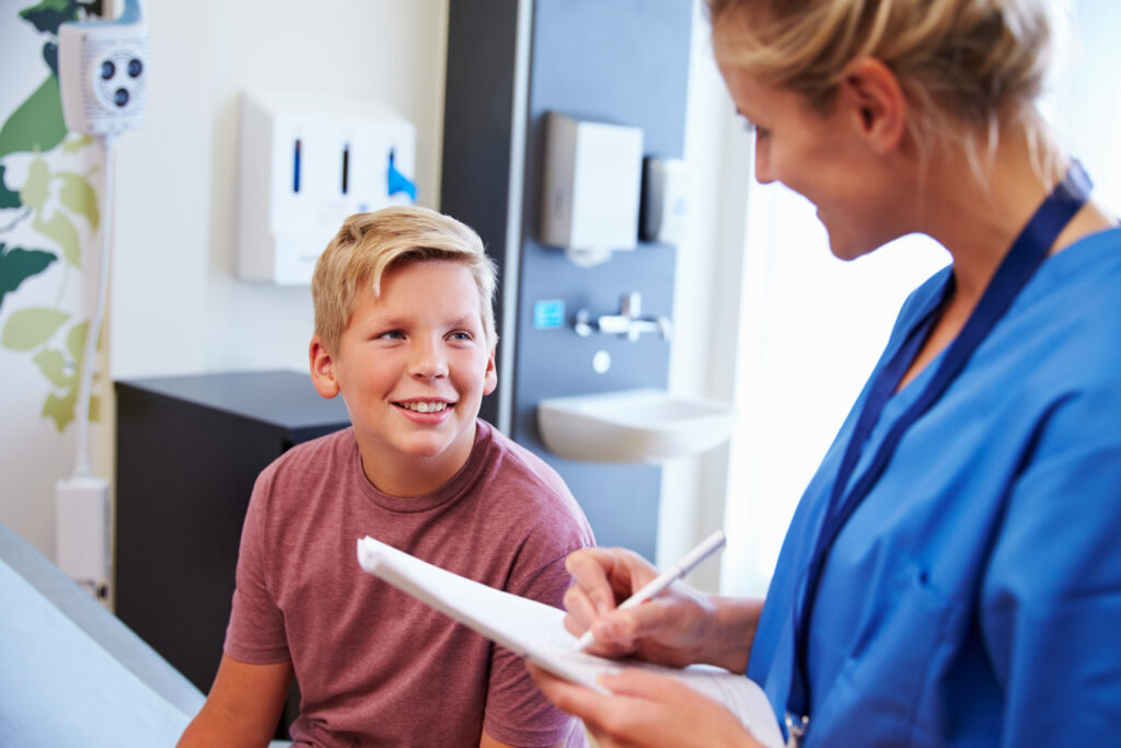 Young teen talking to female health professional
