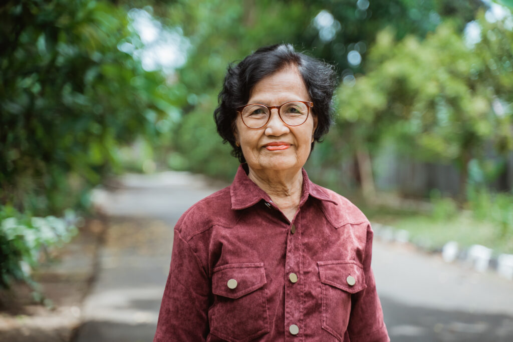 Older asian women looking at camera outdoors