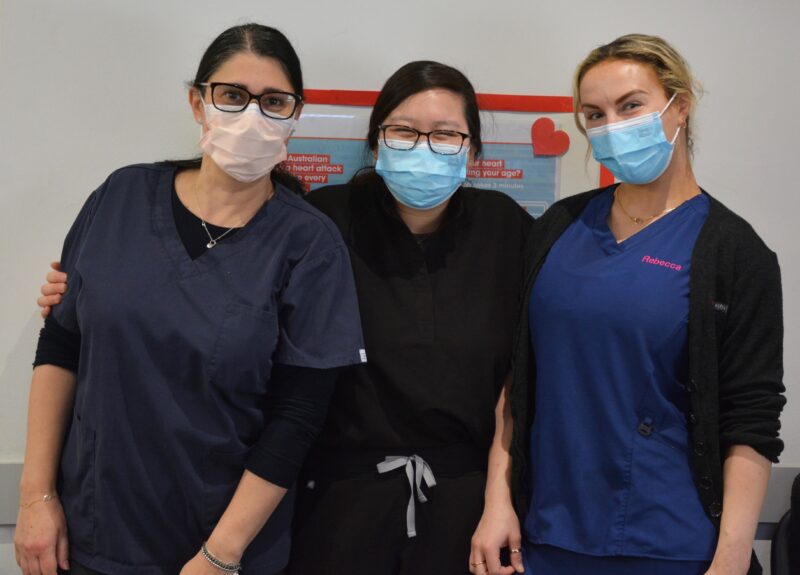 Three female nursing staff wearing face masks and looking at the camera