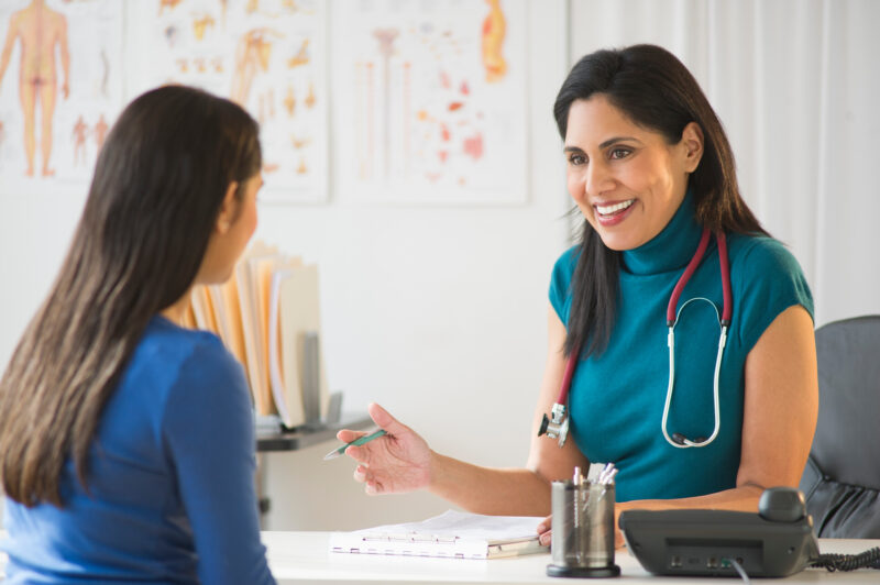 A female doctor talking to a female patient