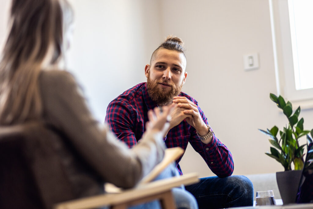 Young male adult sitting and talking to someone